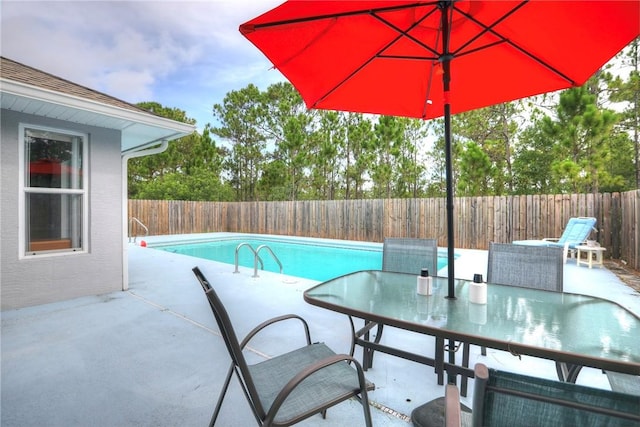 view of swimming pool featuring a patio area