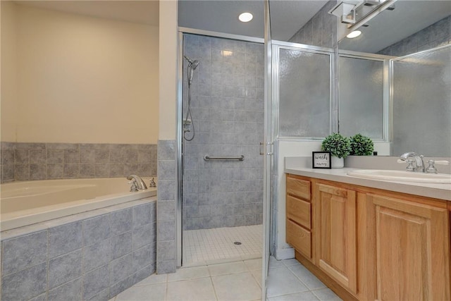 bathroom with independent shower and bath, vanity, and tile patterned floors