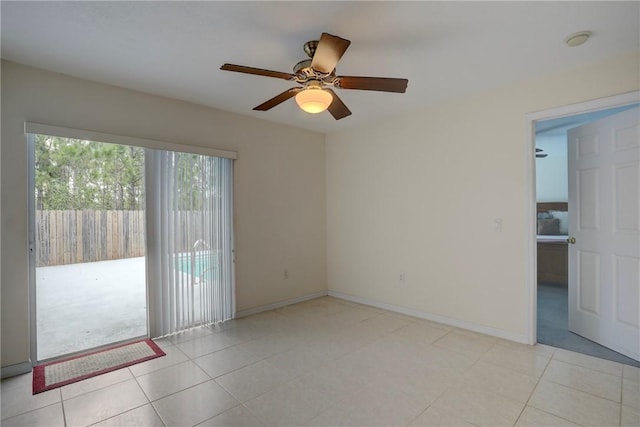 tiled spare room featuring ceiling fan