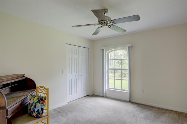 sitting room featuring light colored carpet and ceiling fan