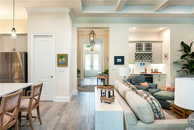 living room with crown molding, light wood-type flooring, indoor bar, and beam ceiling