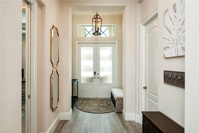 foyer featuring ornamental molding, french doors, and wood-type flooring