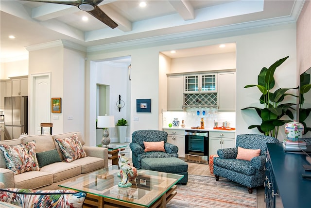 living room featuring light hardwood / wood-style floors, beamed ceiling, wine cooler, bar area, and crown molding