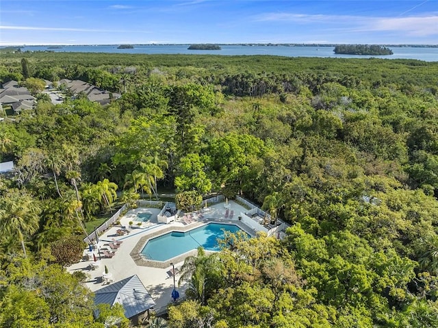 aerial view featuring a wooded view and a water view