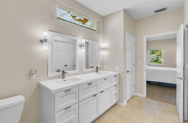 full bathroom featuring tile patterned flooring, visible vents, toilet, and a sink