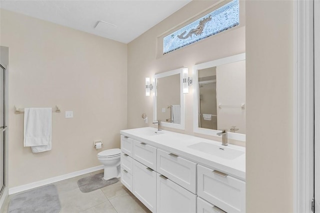 full bathroom with a sink, baseboards, a stall shower, and tile patterned flooring