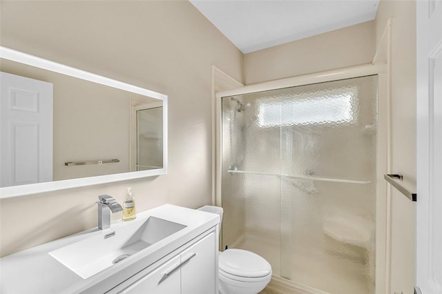 full bath with vanity, toilet, and a stall shower