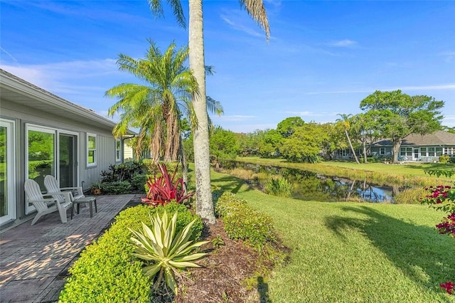 view of yard featuring a patio area and a water view