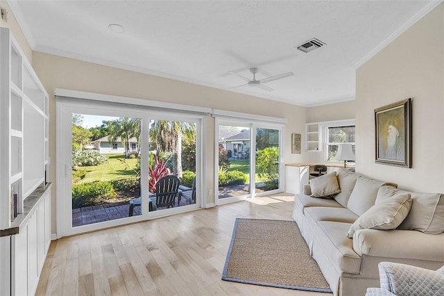 unfurnished sunroom with a ceiling fan and visible vents