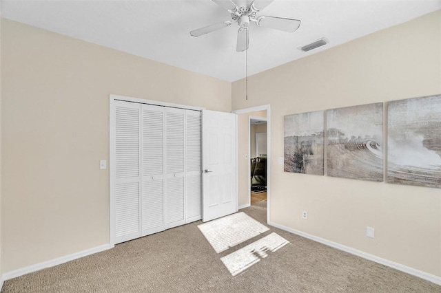 unfurnished bedroom with a closet, visible vents, baseboards, and carpet