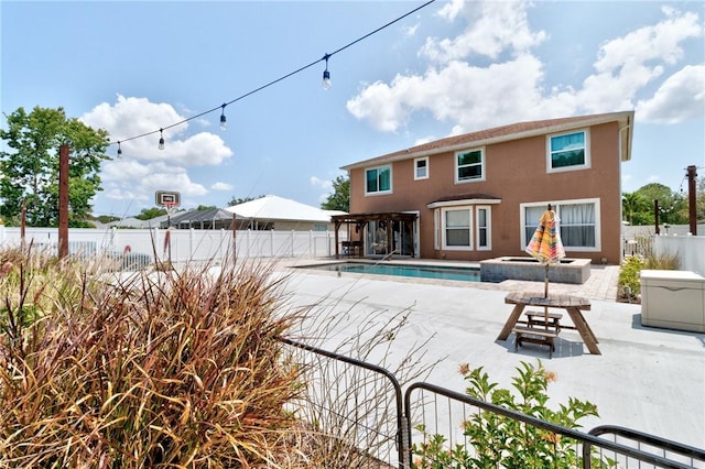 4565 61st Ter, Vero Beach, FL 32967 - back of property featuring a fenced backyard, a patio area, stucco siding, and an in-ground hot tub