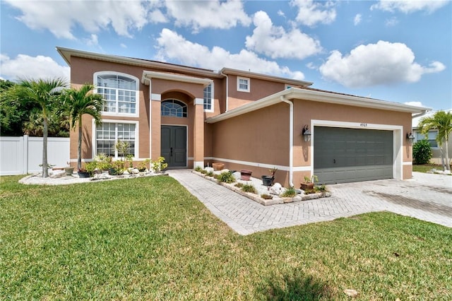 4565 61st Ter, Vero Beach, FL 32967 - view of front facade featuring stucco siding, an attached garage, and decorative driveway