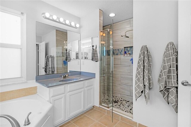 4565 61st Ter, Vero Beach, FL 32967 - bathroom featuring a stall shower, vanity, tile patterned floors, and a bath