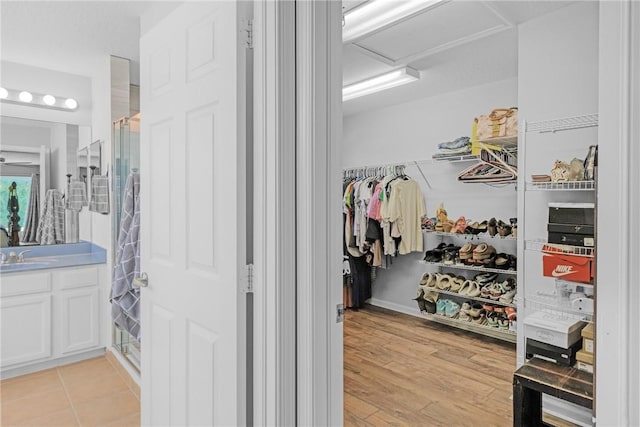 4565 61st Ter, Vero Beach, FL 32967 - walk in closet with attic access, a sink, and light wood-style flooring