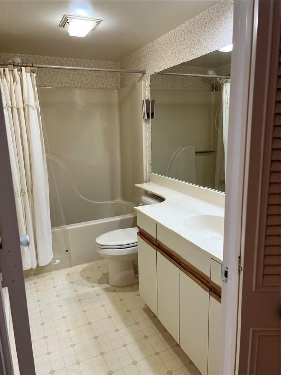 bathroom with vanity, toilet, tile patterned floors, and shower / bath combination with curtain