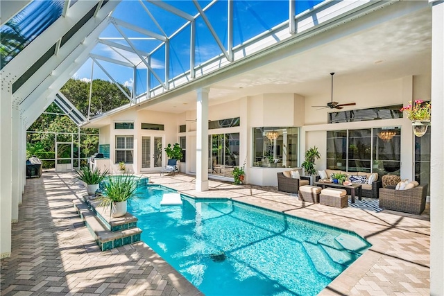 outdoor pool with a ceiling fan, a patio, glass enclosure, french doors, and outdoor lounge area