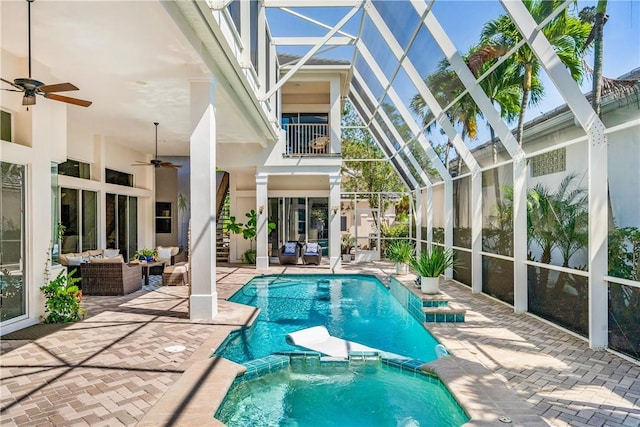 view of pool with ceiling fan, a patio, a lanai, an outdoor hangout area, and a pool with connected hot tub