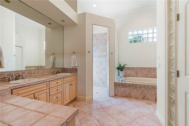 bathroom featuring ornamental molding, separate shower and tub, tile patterned floors, and vanity