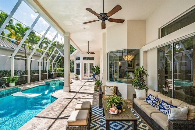 dining room with ornate columns, light tile patterned flooring, ceiling fan with notable chandelier, and french doors