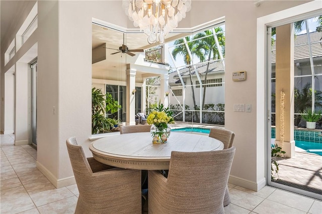 dining area with light tile patterned floors, baseboards, and a chandelier