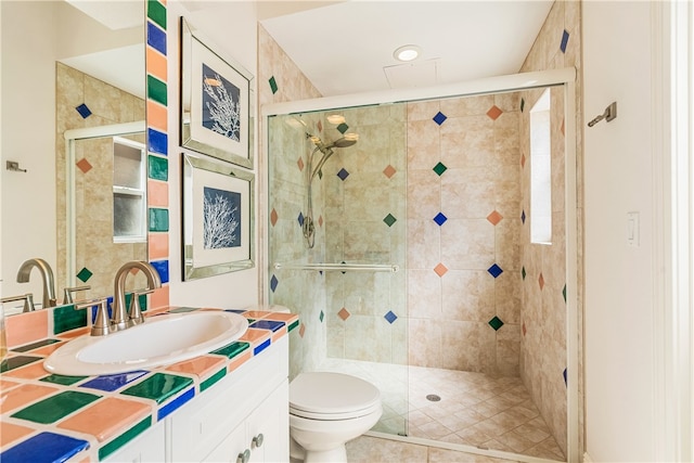 bathroom featuring tile patterned flooring, vanity, an enclosed shower, and toilet