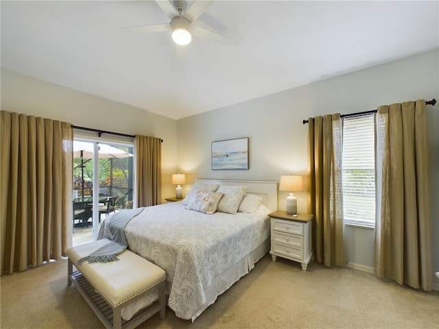 carpeted bedroom featuring access to exterior and ceiling fan