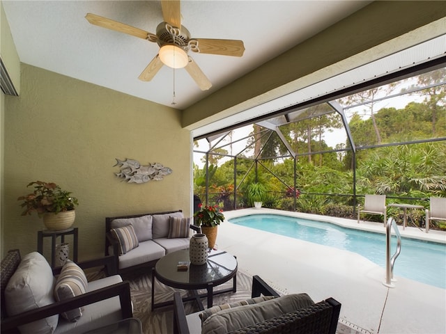 view of pool with an outdoor living space, a patio area, and glass enclosure