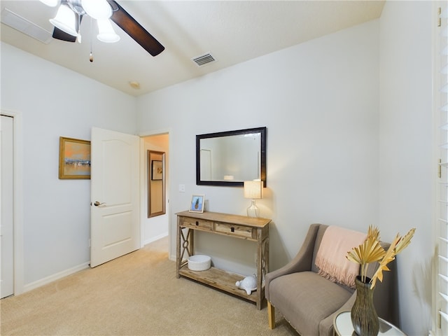 sitting room featuring light colored carpet and ceiling fan