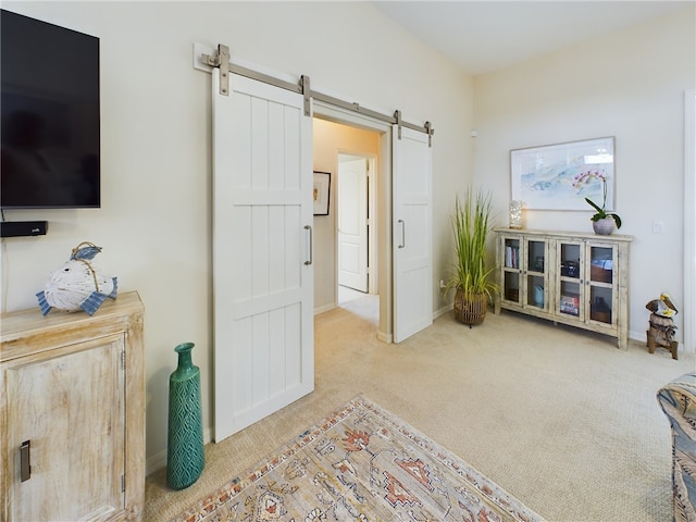 interior space with a barn door and light carpet