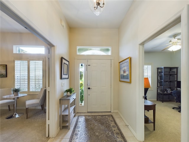 carpeted foyer featuring ceiling fan