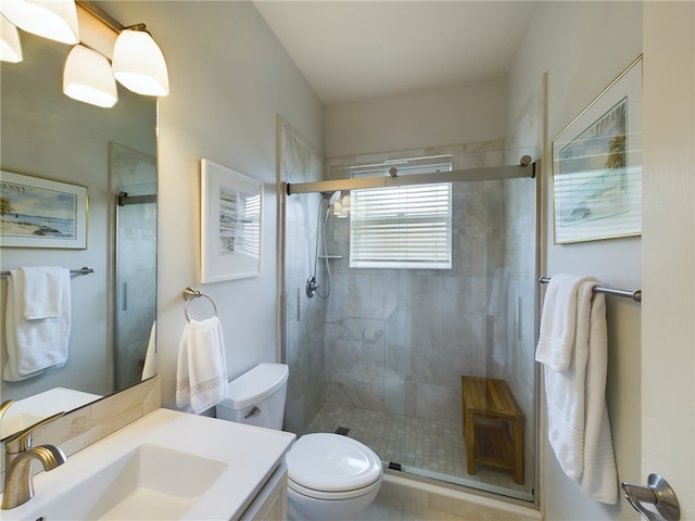 bathroom featuring vanity, toilet, and an enclosed shower