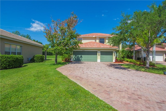 view of front of home featuring stucco siding, decorative driveway, a front lawn, a garage, and a tiled roof