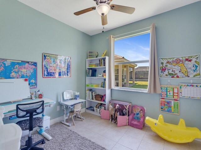 game room with tile patterned floors, baseboards, and a ceiling fan