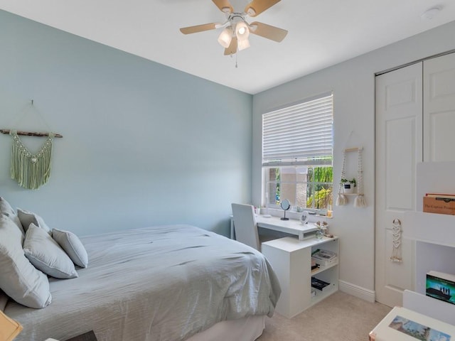 carpeted bedroom featuring baseboards and a ceiling fan
