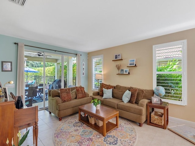 living area featuring visible vents, baseboards, a ceiling fan, and light tile patterned floors