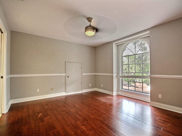 unfurnished room featuring a ceiling fan, baseboards, and wood finished floors