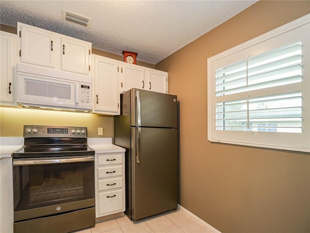 kitchen featuring stainless steel appliances, light countertops, visible vents, and white cabinets