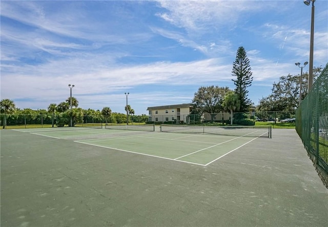 view of tennis court with fence