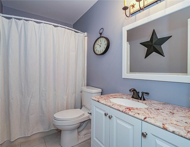 bathroom with tile patterned flooring, vanity, and toilet