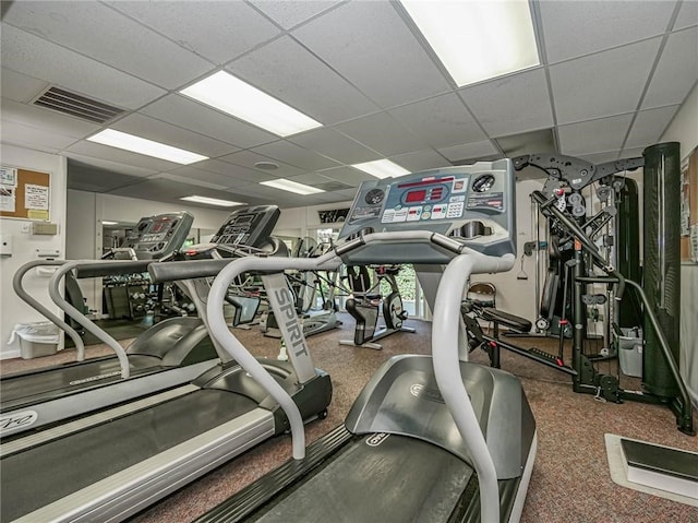 exercise room featuring a paneled ceiling