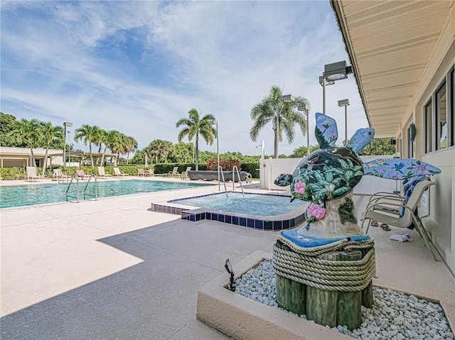 community pool featuring a hot tub and a patio