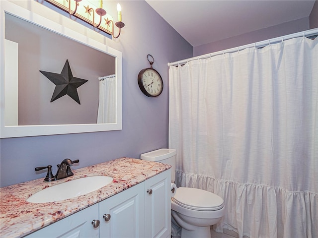 bathroom featuring vanity, toilet, and curtained shower