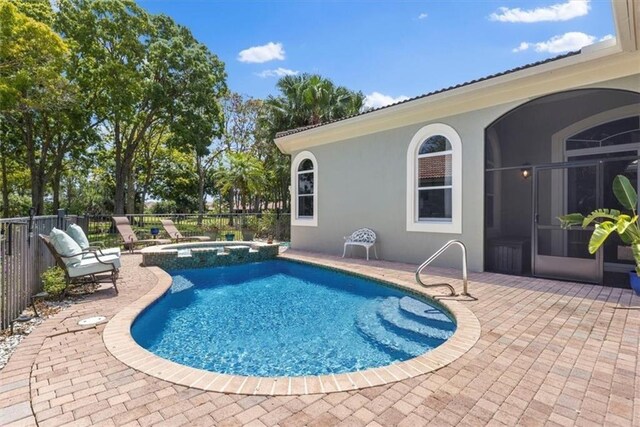 2214 Falls Cir, Vero Beach, FL 32967 - view of swimming pool with a patio and an in ground hot tub