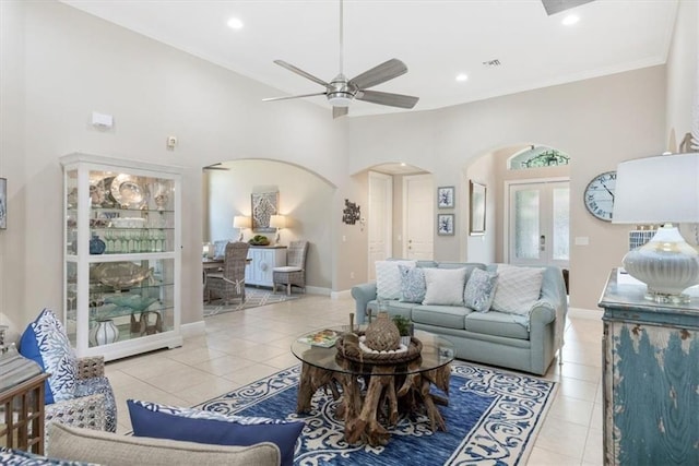 2214 Falls Cir, Vero Beach, FL 32967 - living room with light tile patterned flooring, ceiling fan, french doors, and a towering ceiling
