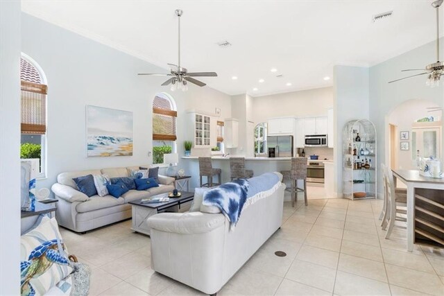 2214 Falls Cir, Vero Beach, FL 32967 - tiled living room featuring ceiling fan and a high ceiling