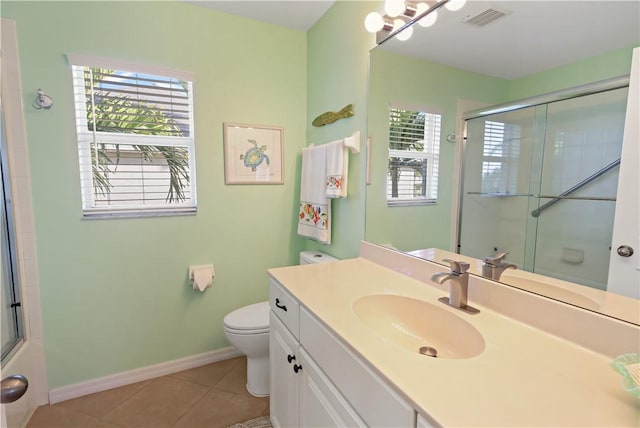 5688 Riverboat Cir SW, Vero Beach, FL 32968 - bathroom featuring plenty of natural light, toilet, tile patterned flooring, and a shower with door