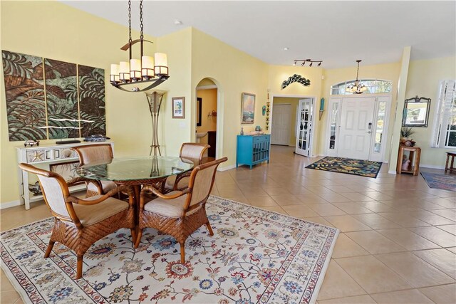 5688 Riverboat Cir SW, Vero Beach, FL 32968 - dining room with a chandelier, arched walkways, light tile patterned floors, baseboards, and recessed lighting