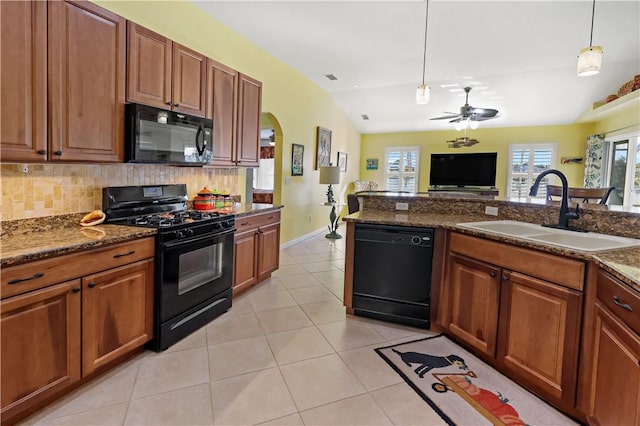 5688 Riverboat Cir SW, Vero Beach, FL 32968 - kitchen featuring black appliances, a sink, a ceiling fan, tasteful backsplash, and arched walkways
