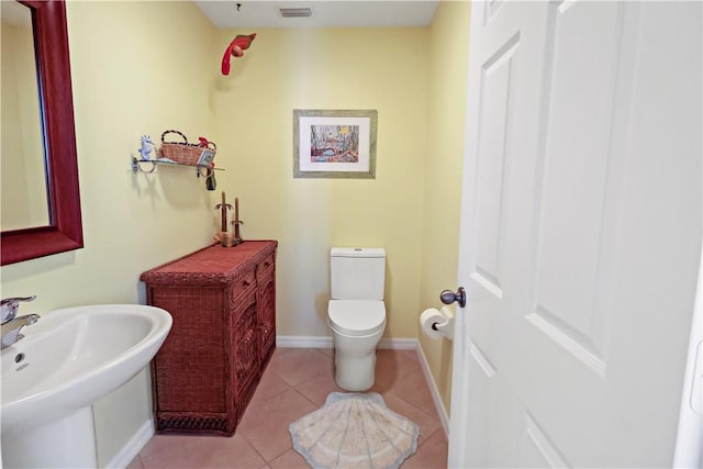 5688 Riverboat Cir SW, Vero Beach, FL 32968 - half bathroom featuring toilet, tile patterned floors, baseboards, and a sink