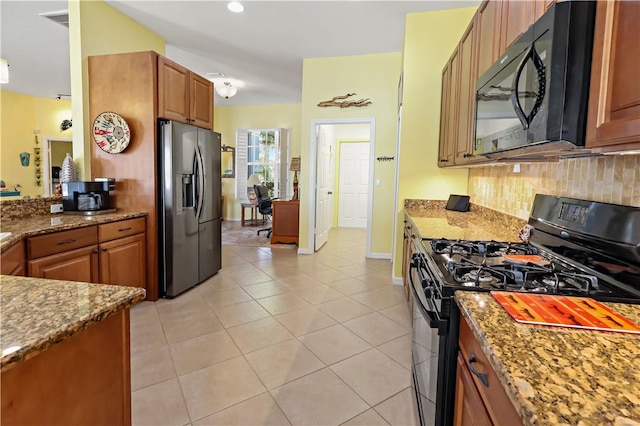 5688 Riverboat Cir SW, Vero Beach, FL 32968 - kitchen featuring black appliances, tasteful backsplash, light stone counters, and brown cabinetry